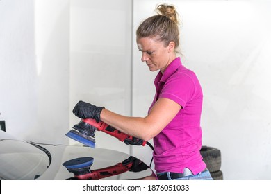 Woman Polishing Car Body In Service