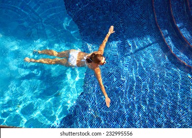 Woman In The Pool. Vacation At Caribbean Resort       