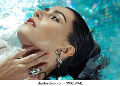 Woman At A Pool Wearing Sapphire Jewelry