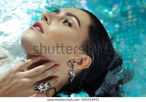 Woman At a Pool\
Wearing Sapphire Jewelry