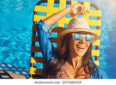 Woman, poolside and relax on holiday chair, outdoor and travel to hotel resort for vacation. Female person, peace and sunglasses by water to rest, smile and calm by swimming pool for luxury wellness - Powered by Shutterstock