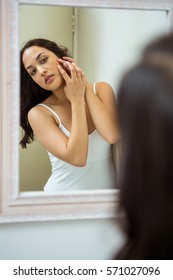 Woman Popping Her Pimple In Bathroom