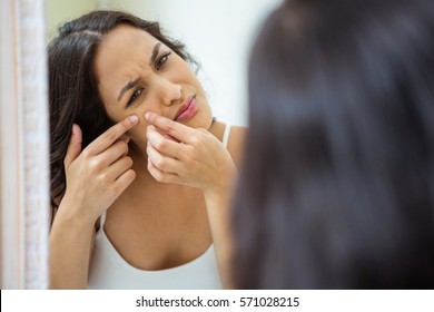 Woman Popping Her Pimple In Bathroom