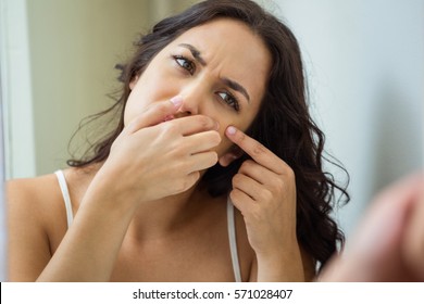 Woman Popping Her Pimple In Bathroom