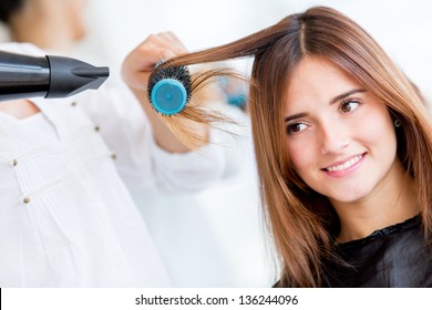 Woman Portrait Blow Drying Her Hair At The Beauty Salon