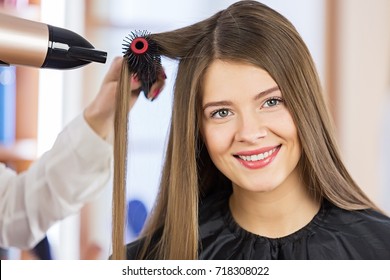 Woman Portrait Blow Drying Her Hair At The Beauty Salon.