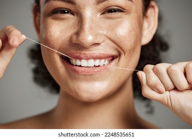 Woman portrait, dental floss and flossing teeth with smile for oral hygiene, health and wellness on studio background. Face of female happy about self care, healthcare and grooming for healthy mouth - Shutterstock ID 2248535651