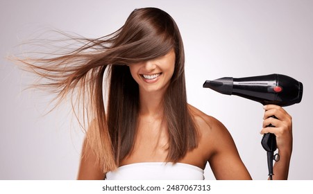 Woman, portrait and hair care in studio with hairdryer for beauty, glow and transformation with shine. Hairdresser, face and electric equipment on white background for texture, growth and balayage