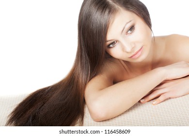 woman portrait with long shiny laying hair on horizontal surface