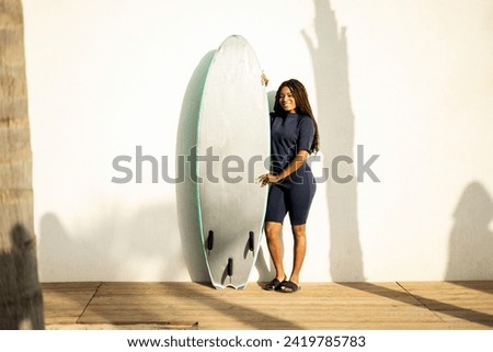 Similar – Brunette surfer woman with top holding surfboard