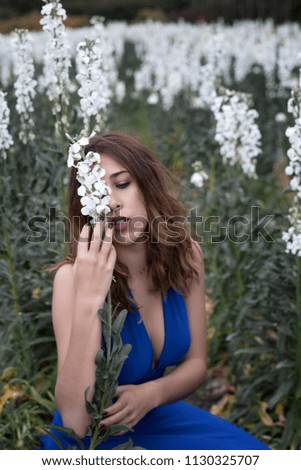 Woman posing in field of white flowers