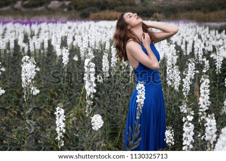 Woman posing in field of white flowers