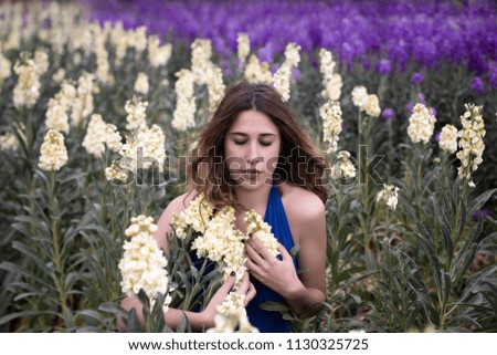 Woman posing in field of white flowers