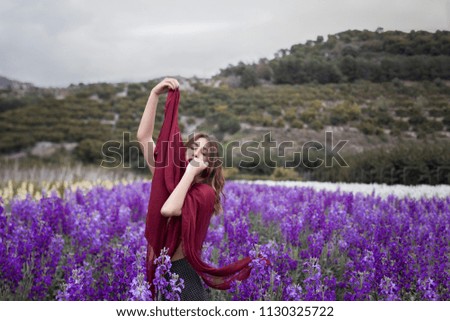 Woman posing in flower field with a handkerchief