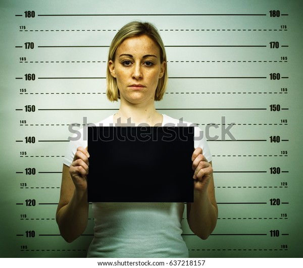 woman posing for police\
mugshot