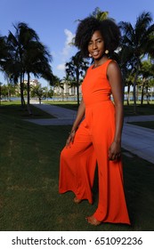 Woman Posing In A Retro Orange Jump Suit