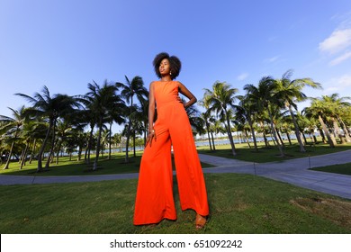 Woman Posing In A Retro Orange Jump Suit