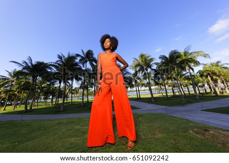 Woman posing in a retro orange jump suit