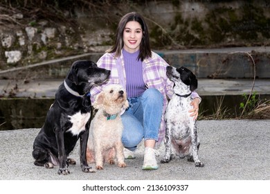 Woman Posing With Three Adopted Dogs. Dog Adoption