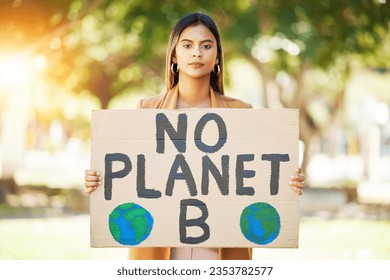 Woman, poster and save planet sign at park for climate change, environment and green eco friendly protest. Young person in portrait and nature, earth or globe support for sustainable world and action