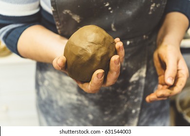 Woman Potter In Apron, Hand Holds Lump Of Clay