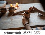 Woman potter hands gently wet and align clay cup with sponge on workshop table, ensuring smooth surface. Pottery ceramic technique, handmade crockery, artisanal craft, small business, pottery school