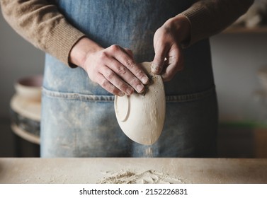 Woman potter making ceramic bowl from clay working in pottery workshop - Powered by Shutterstock