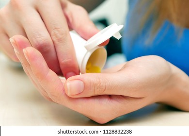 Woman Pouring Bunch Of Prescription Yellow Opiate Pills Into Hand