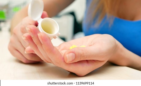 Woman Pouring Bunch Of Prescription Yellow Opiate Pills Into Hand