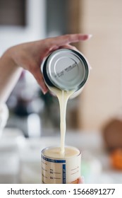 Woman Pouring A Can Of Heavy Cream