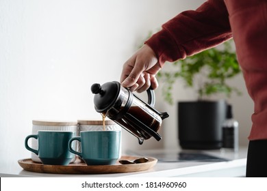 Woman pouring coffee in two coffee cups at morning. Close up - Powered by Shutterstock