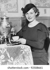 Woman Pouring Coffee From A Coffee Urn