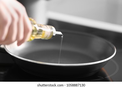 Woman Pouring Cooking Oil Into Frying Pan, Closeup