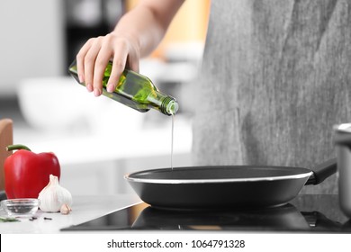 Woman Pouring Cooking Oil Into Frying Pan, Closeup