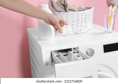 Woman pouring detergent into drawer of washing machine in laundry room, closeup - Shutterstock ID 1212716839