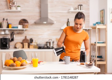 Woman Pouring Hot Coffee In Cup In The Morning From Pot. Housewife At Home Making Fresh Ground Coffee In Kitchen For Breakfast, Drinking, Grinding Coffee Espresso Before Going To Work