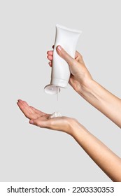 Woman pouring lotion into hand. Cosmetic product branding mockup. Daily skincare and body care routine. Female hand holding  cosmetic product mockup, close up.  - Shutterstock ID 2203330353