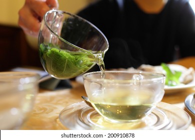 Woman Pouring Mint Tea In The Cafe