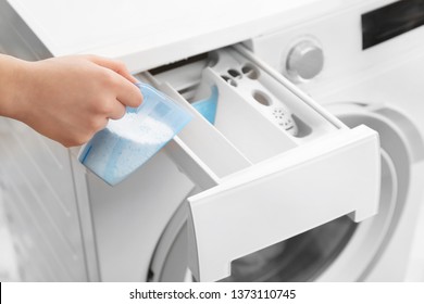 Woman pouring powder into drawer of washing machine, closeup. Laundry day - Shutterstock ID 1373110745