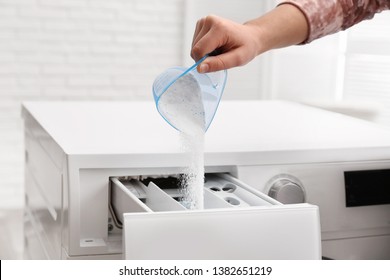 Woman pouring powder into drawer of washing machine indoors, closeup. Laundry day - Shutterstock ID 1382651219