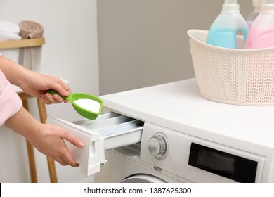 Woman pouring powder into drawer of washing machine in laundry room, closeup - Shutterstock ID 1387625300