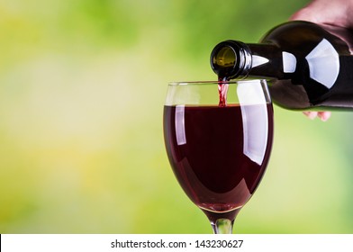 Woman Pouring Red Wine Into Glass