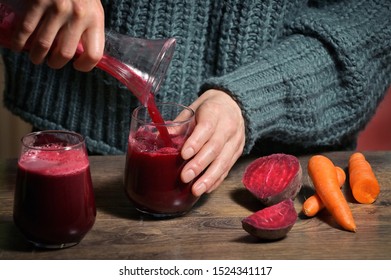 Woman Pouring Self Made Beet Juice In Glass 