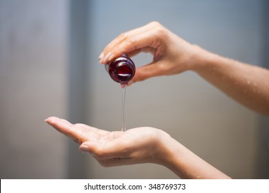 Woman Pouring Shampoo From Bottle Into Hand, Bodywash