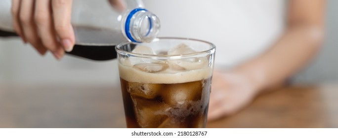 Woman Pouring Soda To Glass For A Refreshing Drink