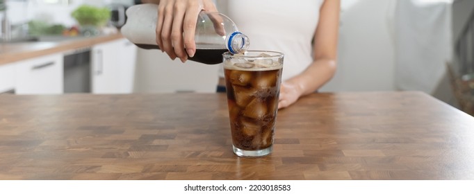 Woman Pouring Soda To Glass For A Refreshing Drink