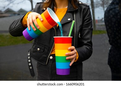 Woman Pouring Soda Into A Glass At A Party. Pride Party Concept.