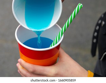 Woman Pouring Soda From One Glass To Another Glass At A Party. Pride Party Concept.