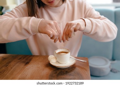 Woman Pouring Sugar From A Bag Into A Cup