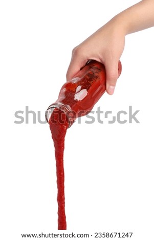 Woman pouring tasty ketchup from bottle isolated on white, closeup